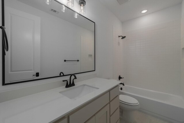 full bathroom with visible vents, bathing tub / shower combination, toilet, and vanity