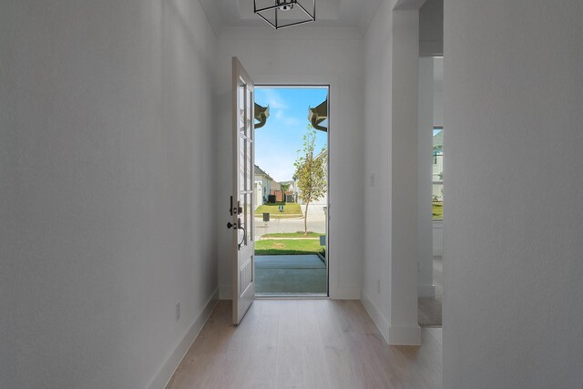 entryway featuring baseboards and light wood-style flooring