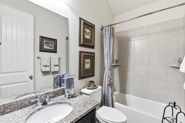 full bathroom with vanity, shower / tub combo, and toilet