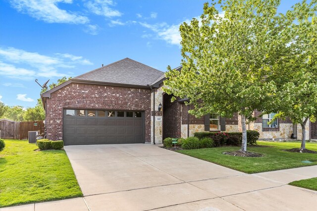 view of front facade with fence, cooling unit, a front yard, and a garage