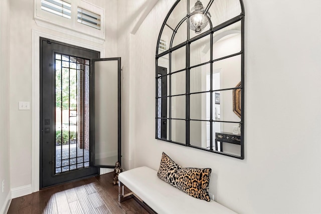 entryway featuring baseboards and wood finished floors