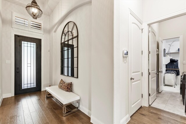entrance foyer with baseboards and wood finished floors