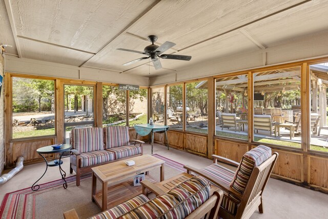 sunroom featuring a ceiling fan and an outdoor hangout area
