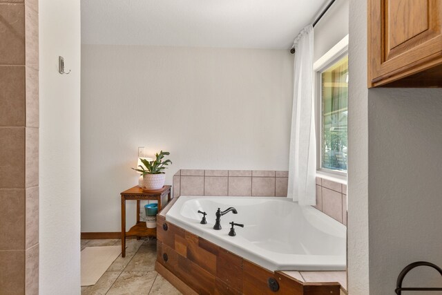 full bathroom featuring tile patterned flooring and a bath