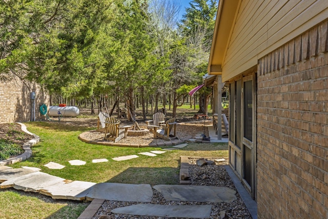 view of yard featuring an outdoor fire pit