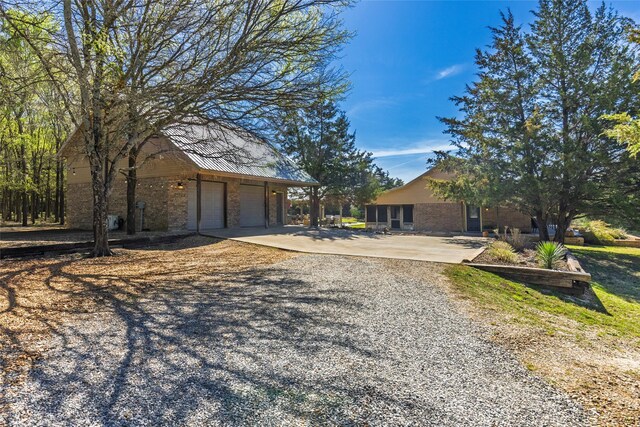 ranch-style house with brick siding, driveway, and a garage