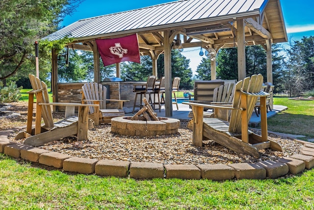 view of play area featuring a gazebo and a fire pit
