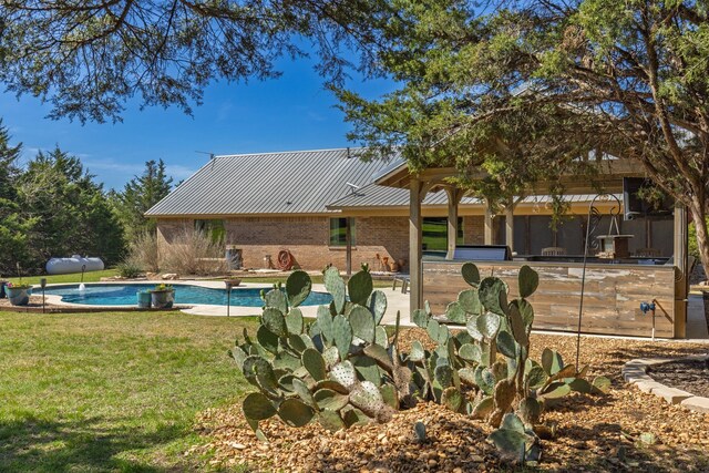 view of patio with exterior kitchen and a grill