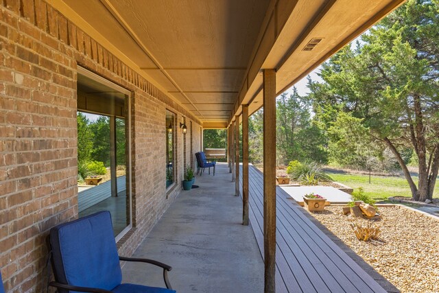 view of patio / terrace featuring a porch and visible vents