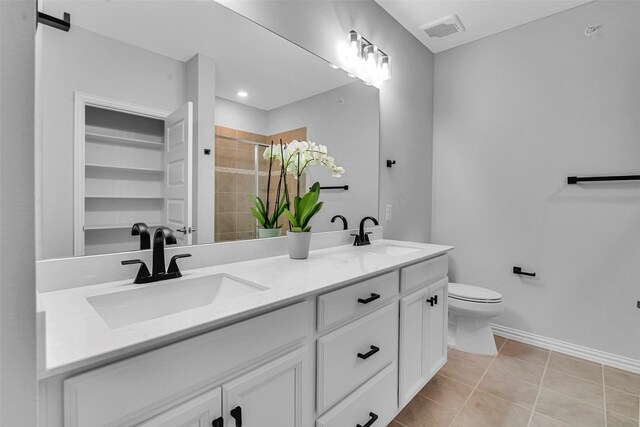full bath featuring visible vents, a sink, tile patterned flooring, and a stall shower