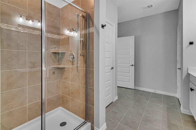 full bathroom with visible vents, a stall shower, vanity, tile patterned floors, and baseboards