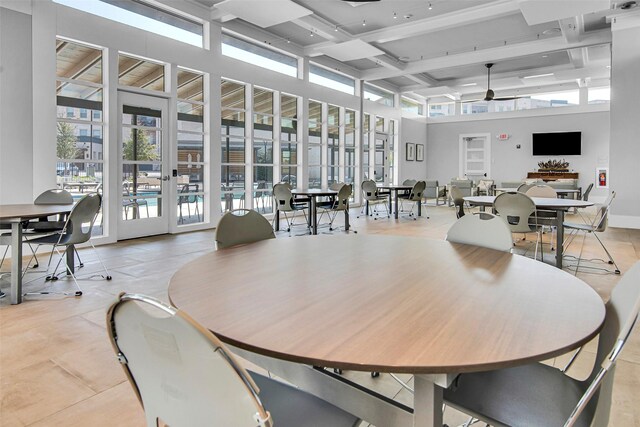 tiled dining area featuring a towering ceiling