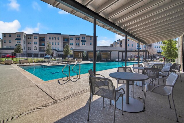 pool featuring a patio area and fence