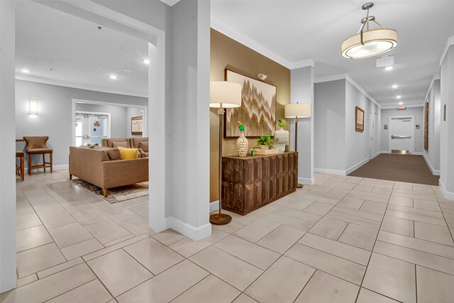 hallway with recessed lighting, baseboards, ornamental molding, and light tile patterned floors