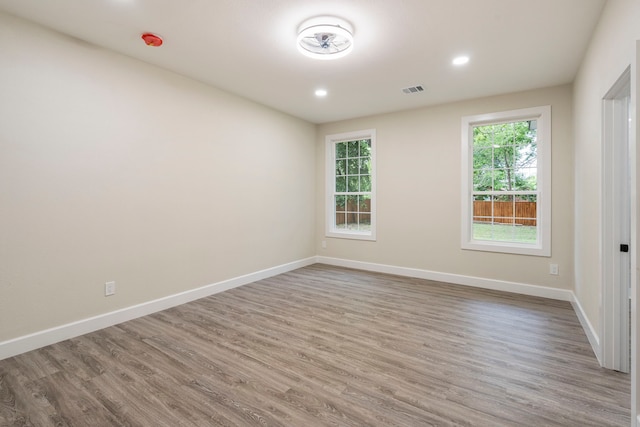 518 S Cockrell Hill Rd, Cockrell Hill, TX 75211 - unfurnished room featuring recessed lighting, baseboards, visible vents, and wood finished floors