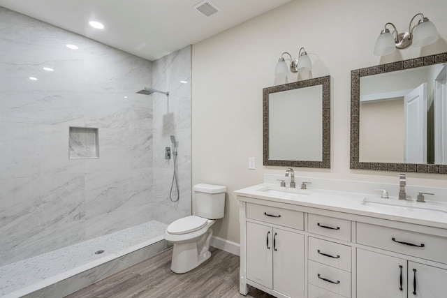 518 S Cockrell Hill Rd, Cockrell Hill, TX 75211 - full bathroom with toilet, visible vents, a sink, and wood finished floors
