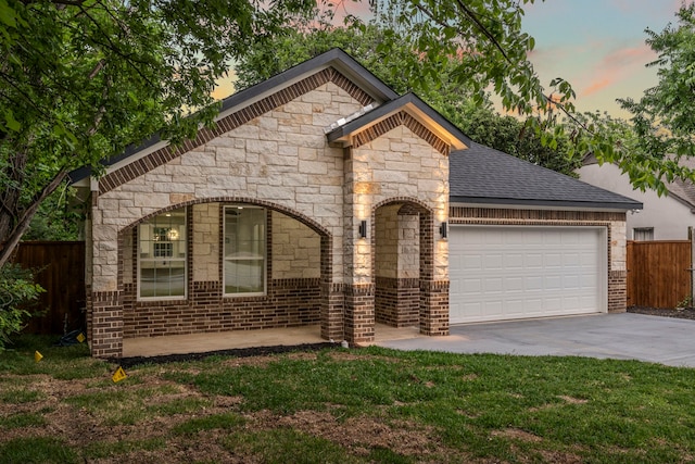 518 S Cockrell Hill Rd, Cockrell Hill, TX 75211 - view of front of home featuring a garage, fence, stone siding, brick siding, and concrete driveway