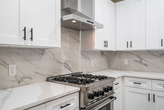 518 S Cockrell Hill Rd, Cockrell Hill, TX 75211 - kitchen with wall chimney range hood, stainless steel range, white cabinets, light stone counters, and backsplash