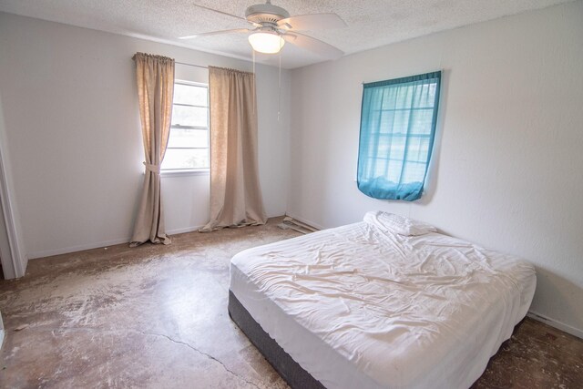 bedroom featuring ceiling fan and a textured ceiling
