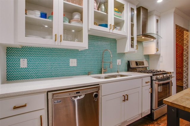 1635 Taft St, Dallas, TX 75208 - kitchen featuring a sink, wall chimney range hood, decorative backsplash, white cabinets, and appliances with stainless steel finishes