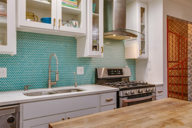 1635 Taft St, Dallas, TX 75208 - kitchen with tasteful backsplash, stainless steel gas stove, a sink, island exhaust hood, and white cabinets