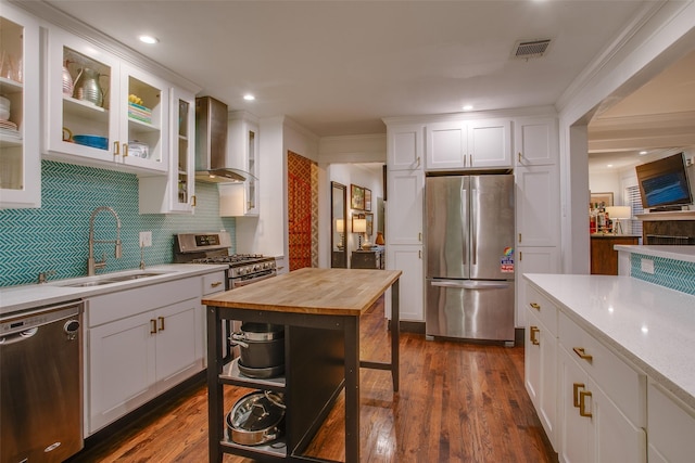 1635 Taft St, Dallas, TX 75208 - kitchen with a sink, wall chimney exhaust hood, white cabinets, butcher block countertops, and appliances with stainless steel finishes