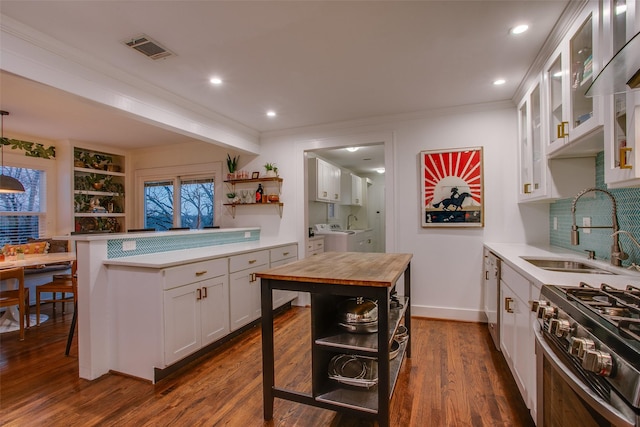 1635 Taft St, Dallas, TX 75208 - kitchen featuring a sink, butcher block counters, open shelves, visible vents, and white cabinetry