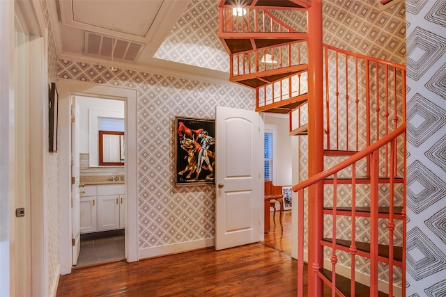 1635 Taft St, Dallas, TX 75208 - staircase with visible vents, wallpapered walls, and wood finished floors