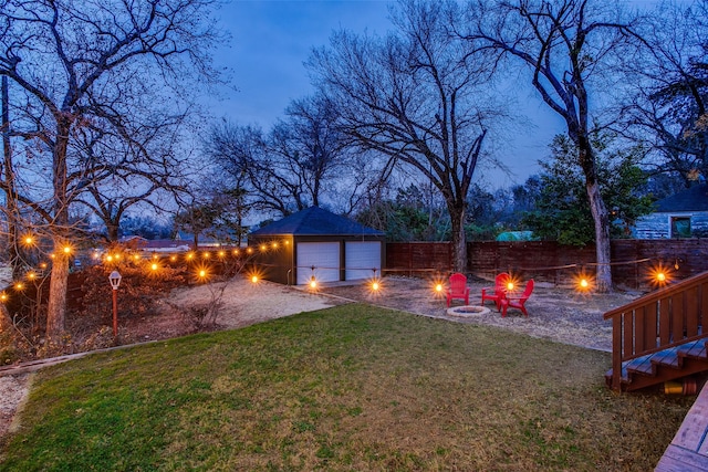 1635 Taft St, Dallas, TX 75208 - view of yard with a garage, an outdoor fire pit, fence, dirt driveway, and an outdoor structure