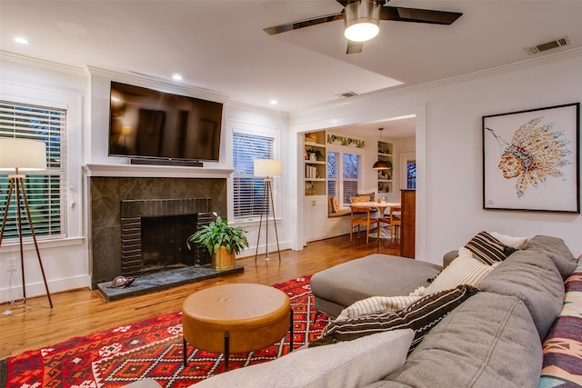 1635 Taft St, Dallas, TX 75208 - living room with crown molding, visible vents, and wood finished floors