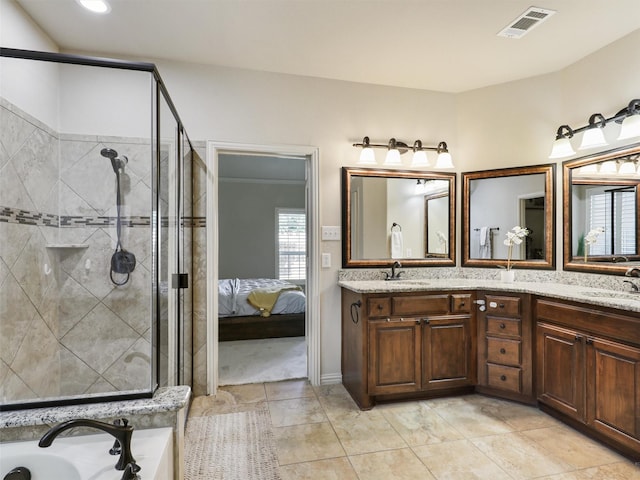 ensuite bathroom featuring visible vents, double vanity, and a tile shower