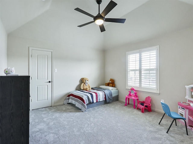 carpeted bedroom with baseboards, a ceiling fan, and vaulted ceiling