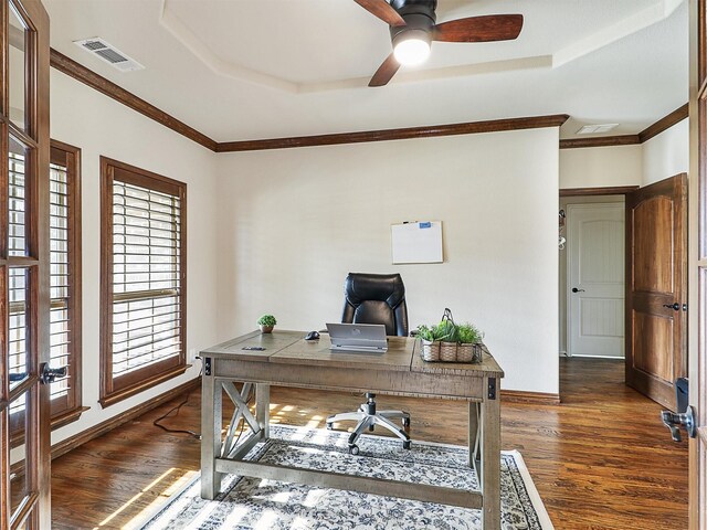 home office with a healthy amount of sunlight, a raised ceiling, dark wood finished floors, and visible vents