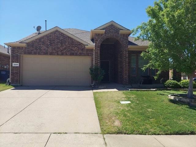 single story home with brick siding, an attached garage, driveway, and a front yard