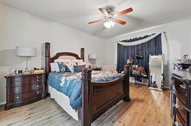 bedroom with baseboards, a ceiling fan, and wood finished floors