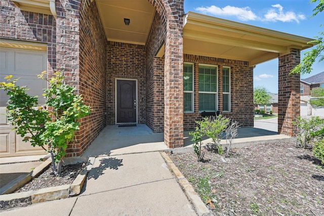doorway to property with brick siding