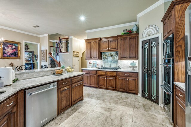 kitchen featuring decorative backsplash, visible vents, light stone countertops, ornamental molding, and stainless steel appliances