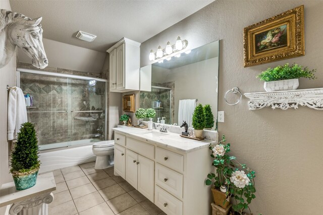 bathroom with visible vents, tile patterned floors, vanity, toilet, and enclosed tub / shower combo
