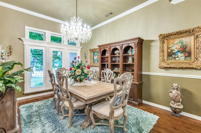 dining area with visible vents, ornamental molding, wood finished floors, baseboards, and a notable chandelier