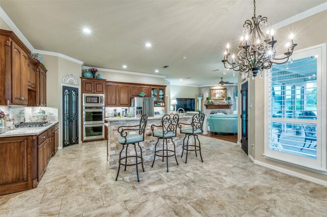 kitchen featuring an inviting chandelier, stainless steel appliances, a large island, a kitchen bar, and backsplash