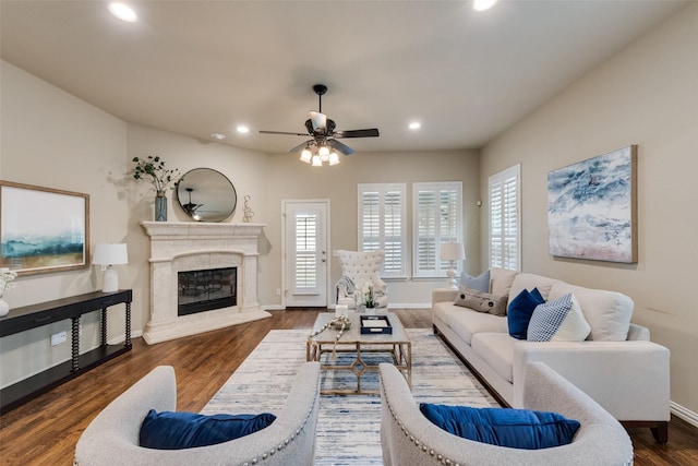 living room with wood finished floors, baseboards, ceiling fan, recessed lighting, and a high end fireplace