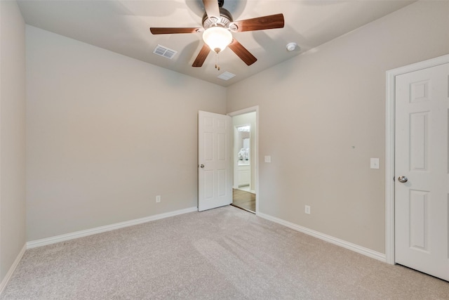 unfurnished bedroom with baseboards, ceiling fan, light colored carpet, and visible vents
