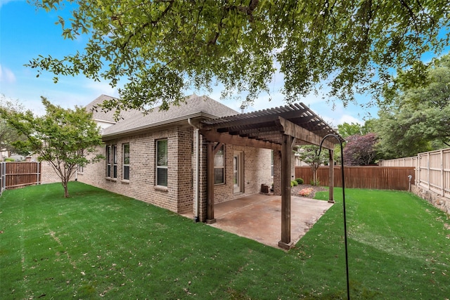 back of house with brick siding, a fenced backyard, a yard, and a pergola