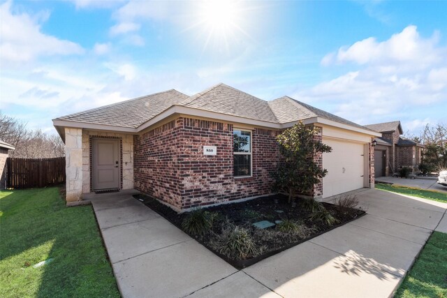 850 Levi Ln, Forney, TX 75126 - view of front of home featuring fence, an attached garage, driveway, and brick siding