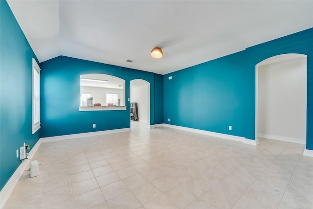 850 Levi Ln, Forney, TX 75126 - tiled spare room with visible vents, arched walkways, and lofted ceiling