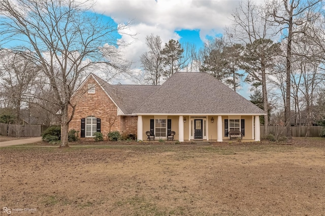 2320 Hidden Cv, Haughton, LA 71037 - view of front of house featuring fence, a shingled roof, stucco siding, a front yard, and covered porch
