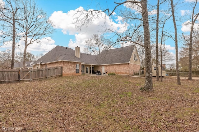 2320 Hidden Cv, Haughton, LA 71037 - rear view of property featuring a fenced backyard, a patio, a chimney, and brick siding
