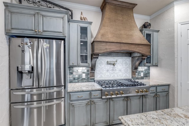 kitchen featuring backsplash, stainless steel appliances, gray cabinetry, and custom exhaust hood