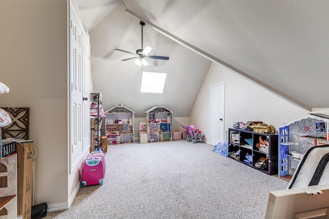 game room featuring carpet flooring, a ceiling fan, and lofted ceiling with skylight