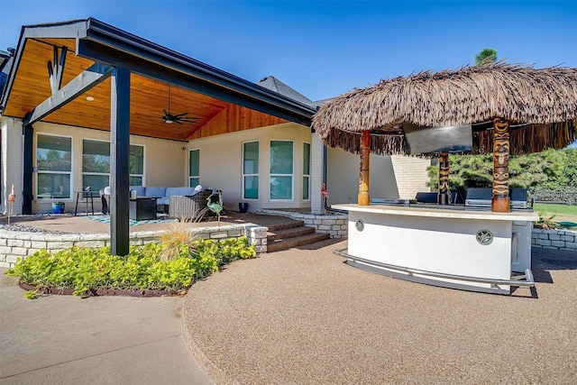 view of patio / terrace featuring a ceiling fan, an outdoor living space, and area for grilling
